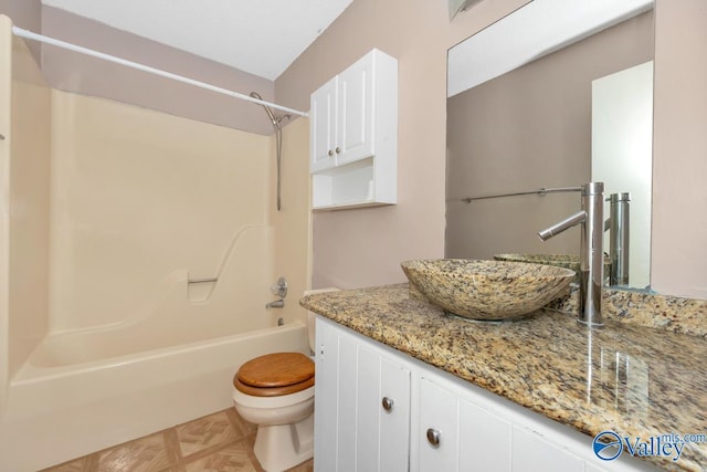 full bathroom featuring tub / shower combination, vanity, and toilet