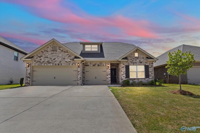 craftsman inspired home featuring a garage and a lawn