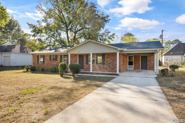 single story home featuring a front yard, covered porch, and a carport