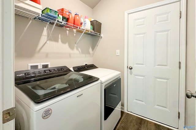 clothes washing area with dark hardwood / wood-style flooring and independent washer and dryer