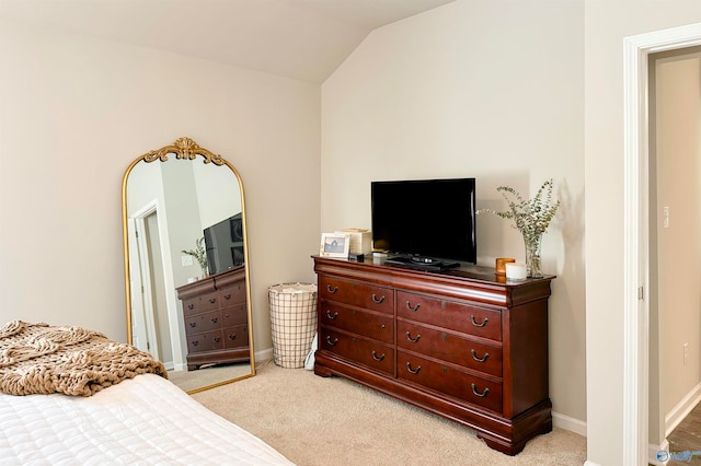 carpeted bedroom featuring lofted ceiling