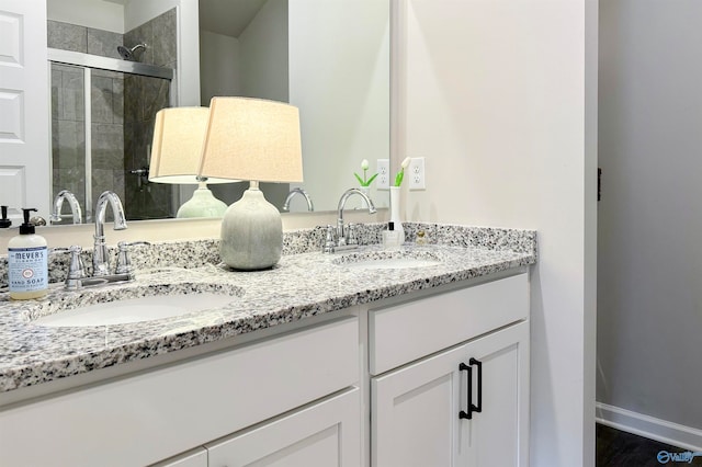 bathroom featuring vanity and an enclosed shower