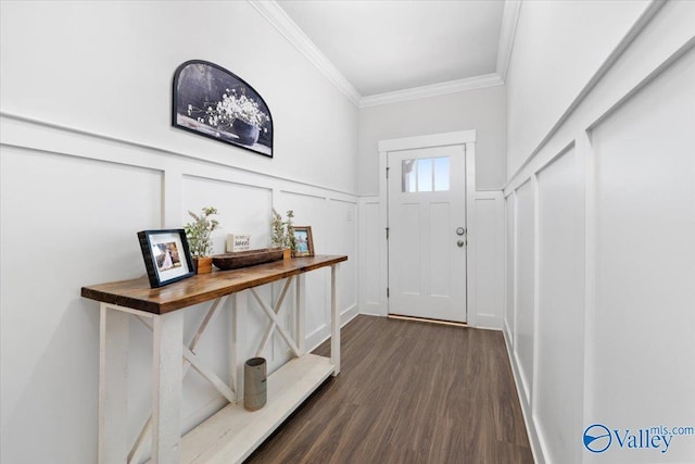 doorway to outside featuring dark wood-type flooring, a wainscoted wall, crown molding, and a decorative wall