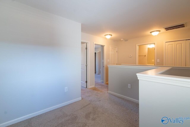 hallway with light carpet