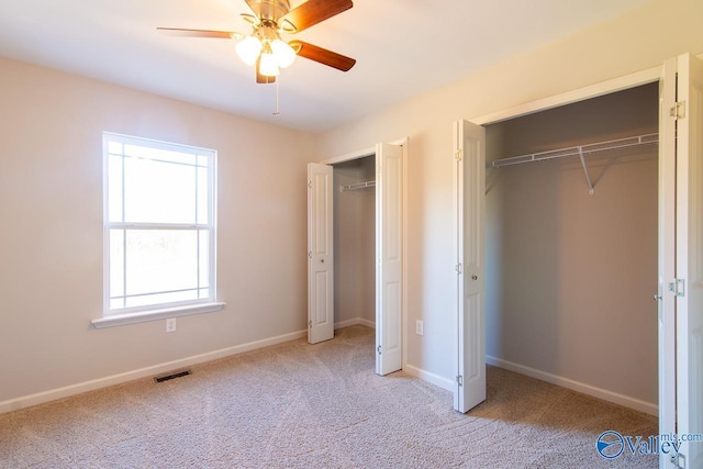 unfurnished bedroom featuring light carpet and ceiling fan