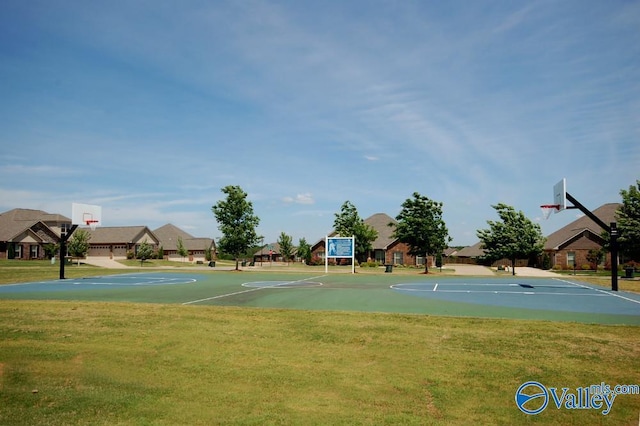 view of sport court with a yard