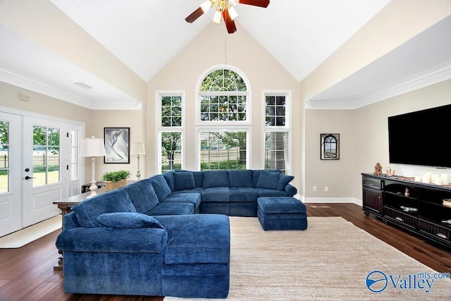 living area with dark wood-style flooring, a ceiling fan, baseboards, and plenty of natural light