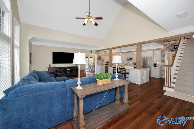 living area featuring a ceiling fan, stairs, dark wood finished floors, and high vaulted ceiling