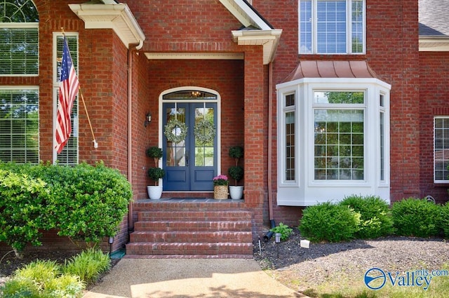 property entrance with brick siding and french doors