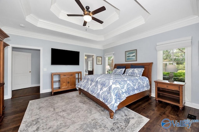 bedroom with ceiling fan, a raised ceiling, ornamental molding, and wood finished floors