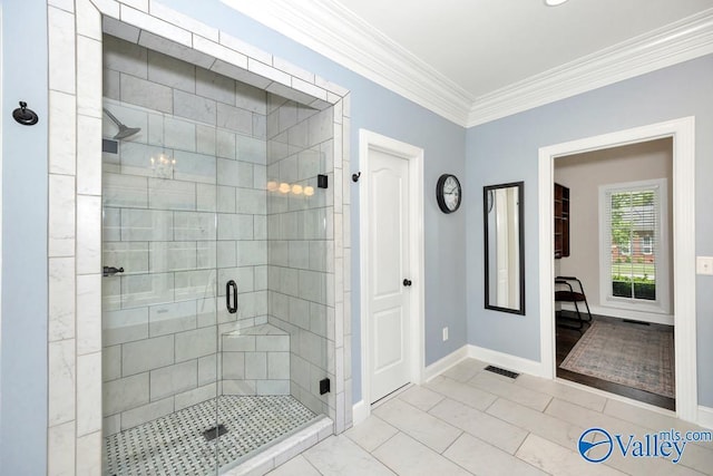 bathroom with visible vents, ornamental molding, baseboards, and a shower stall