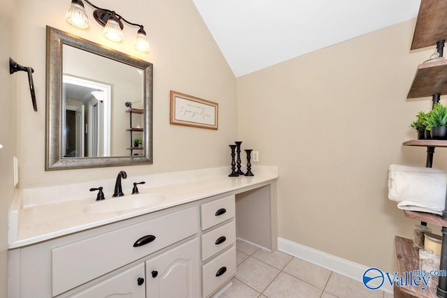 bathroom featuring vanity, tile patterned flooring, baseboards, and lofted ceiling