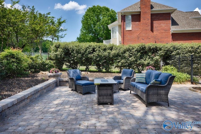 view of patio with fence and outdoor lounge area
