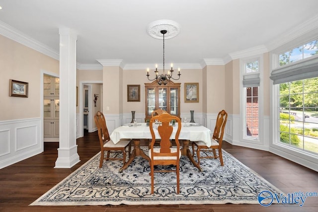 dining space with an inviting chandelier, crown molding, a wealth of natural light, and dark wood-style floors