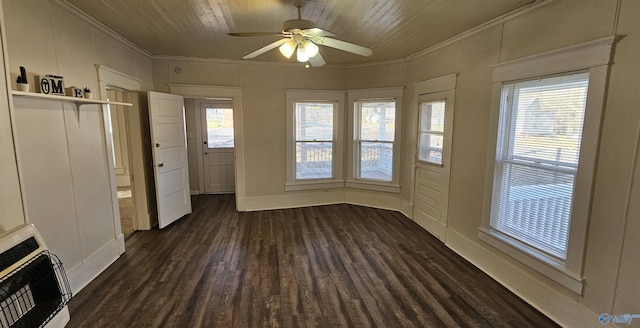 interior space with dark wood-type flooring, crown molding, a decorative wall, and heating unit