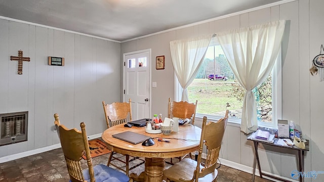 dining area featuring baseboards, heating unit, plenty of natural light, and crown molding