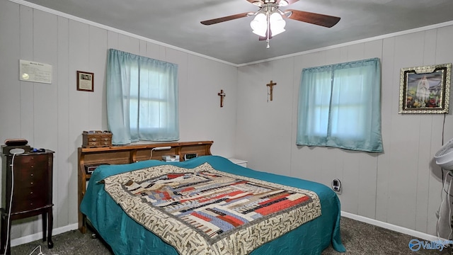 bedroom featuring carpet flooring, baseboards, ornamental molding, and a ceiling fan