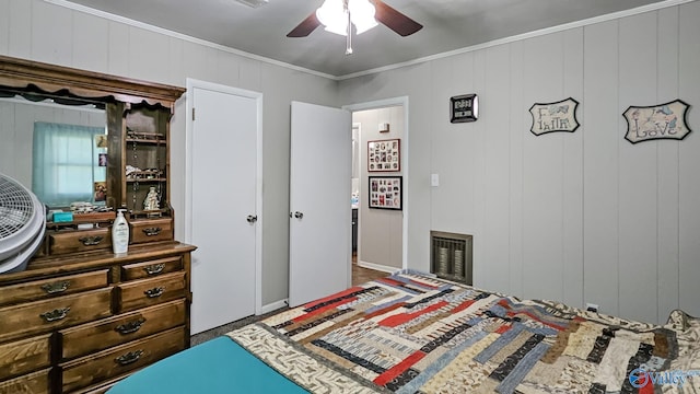 bedroom with ceiling fan, visible vents, and ornamental molding