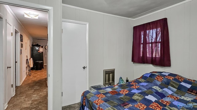 bedroom featuring crown molding and refrigerator