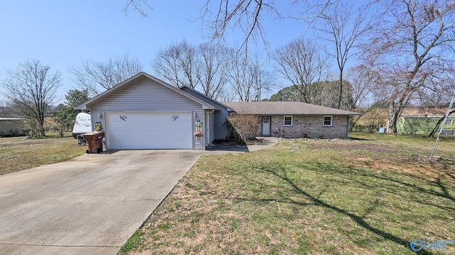 single story home with a front lawn, an attached garage, and driveway