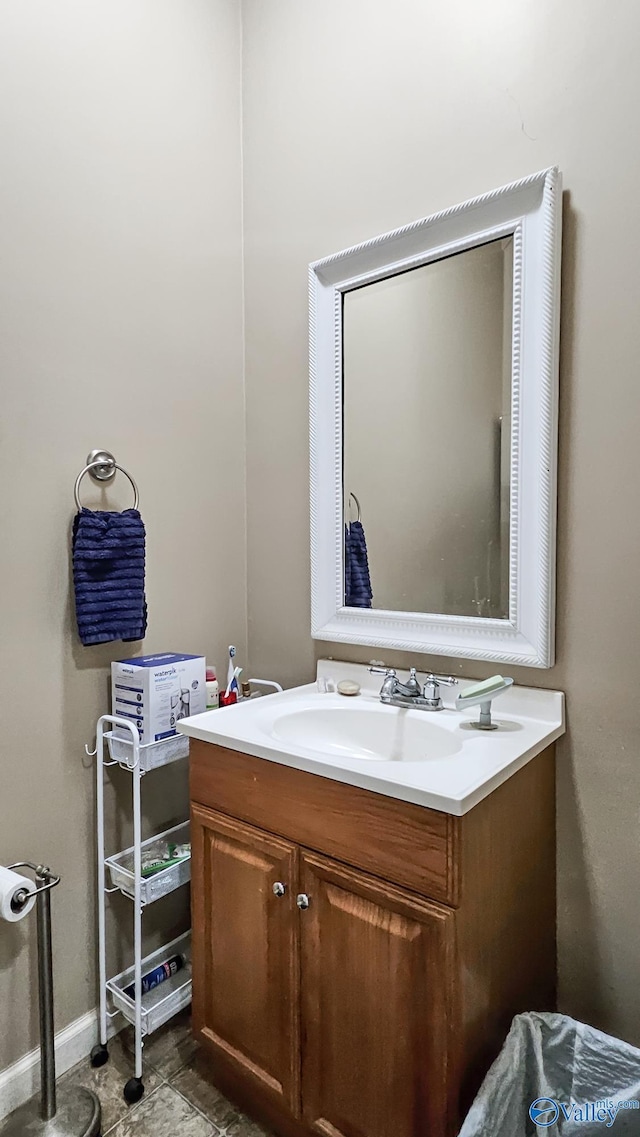 bathroom with baseboards and vanity