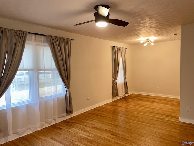 empty room featuring ceiling fan and light wood-type flooring