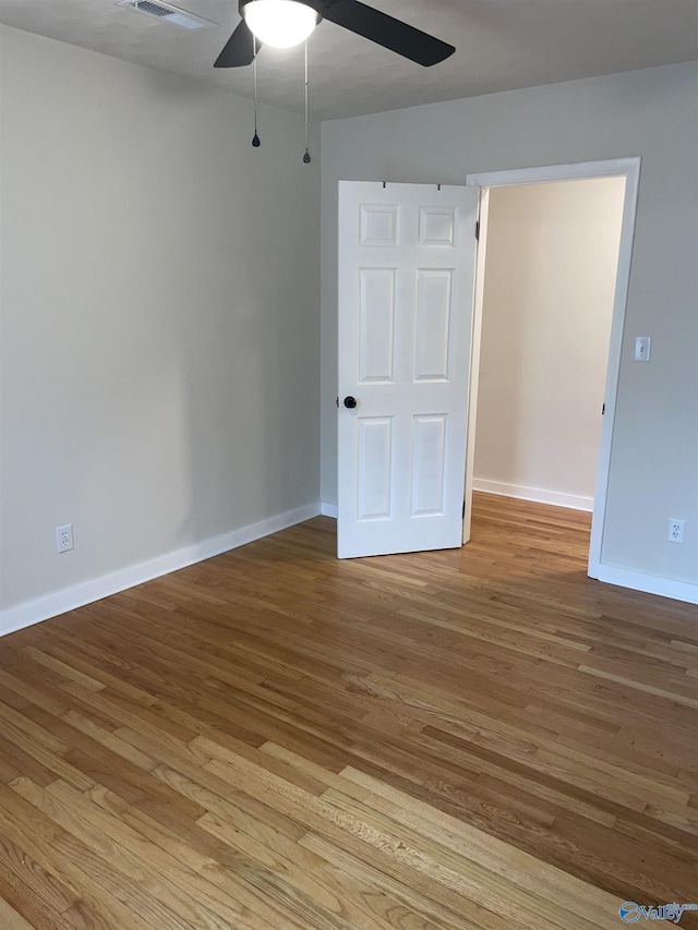 spare room featuring ceiling fan and light wood-type flooring