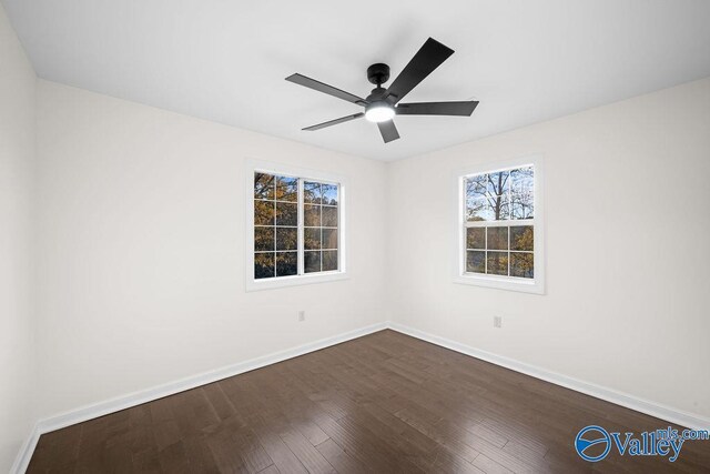 empty room with dark hardwood / wood-style flooring and ceiling fan