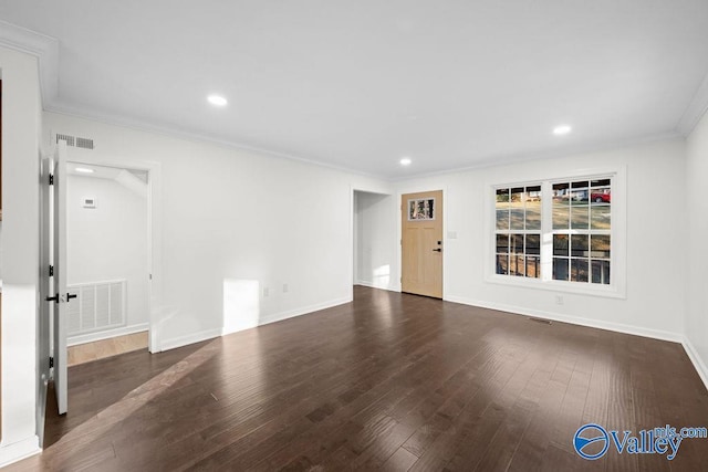 empty room with crown molding and dark hardwood / wood-style floors