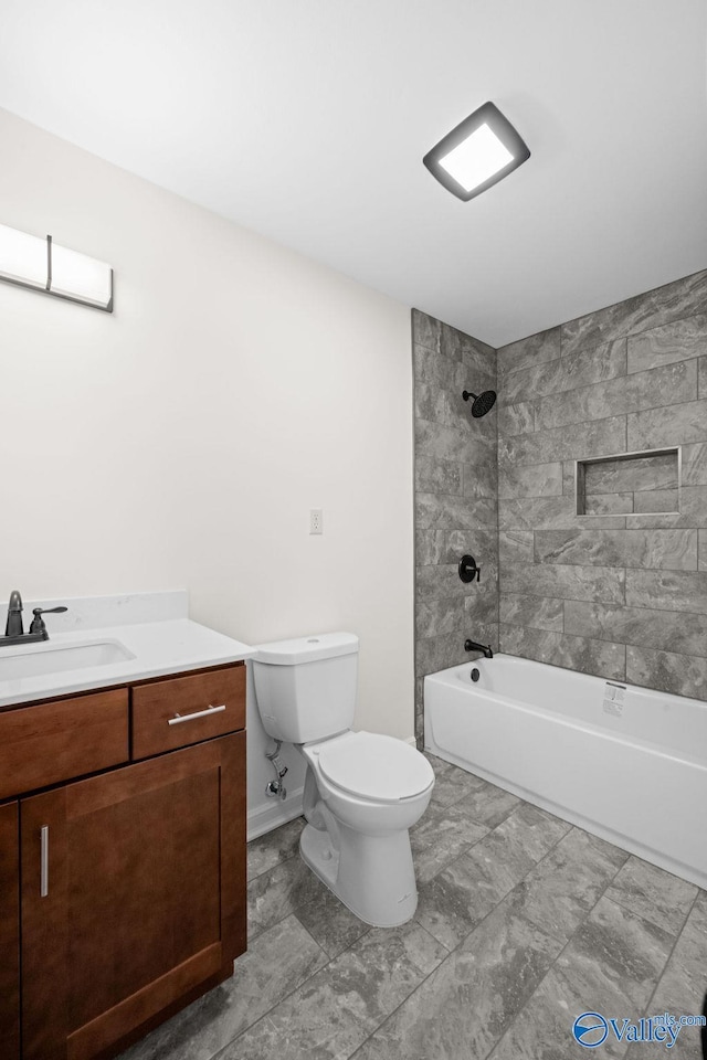 full bathroom featuring vanity, toilet, and tiled shower / bath combo