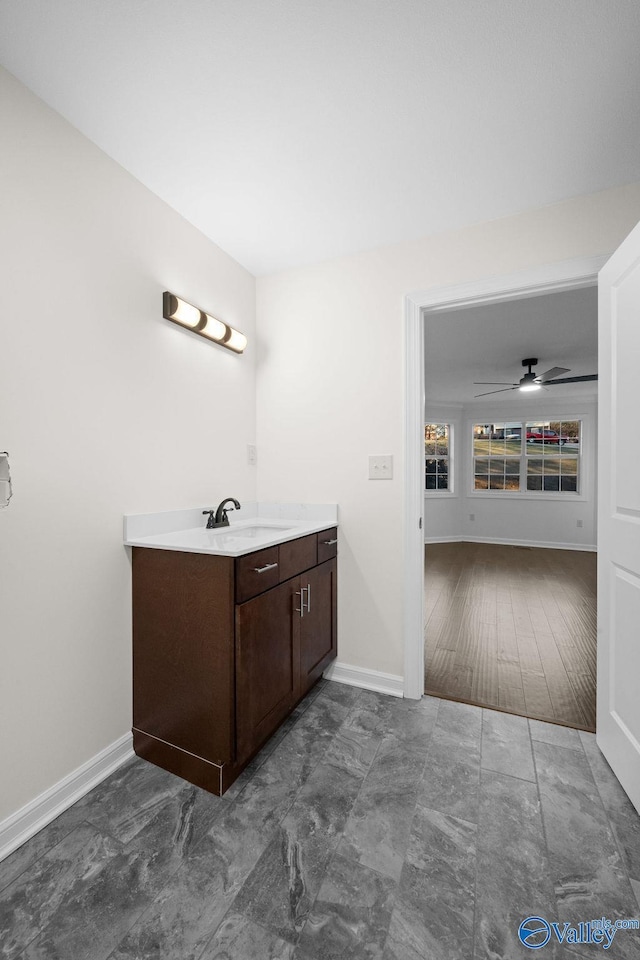 bathroom with ceiling fan, hardwood / wood-style floors, and vanity