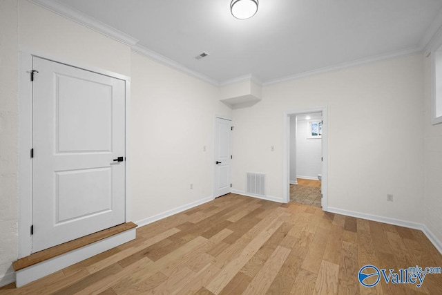 interior space with light wood-type flooring and crown molding