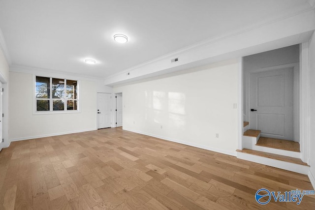 unfurnished room with light hardwood / wood-style floors and crown molding