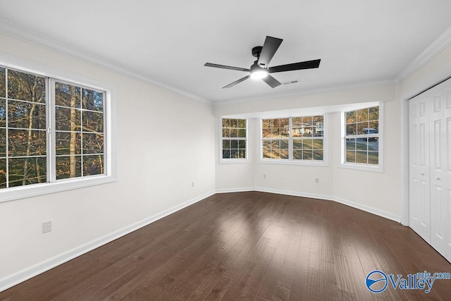 interior space featuring ceiling fan, dark hardwood / wood-style floors, crown molding, and a closet