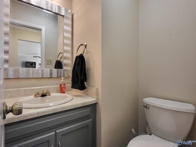 bathroom featuring vanity and toilet