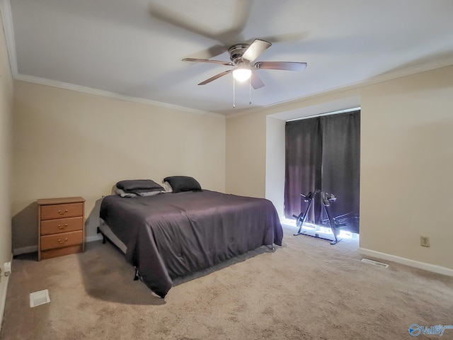 carpeted bedroom featuring ceiling fan and crown molding