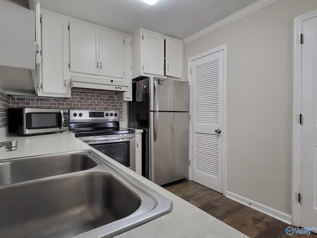 kitchen featuring a textured ceiling, exhaust hood, white cabinetry, stainless steel appliances, and sink