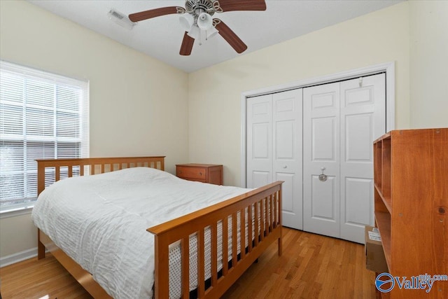 bedroom with a closet, ceiling fan, and light hardwood / wood-style floors