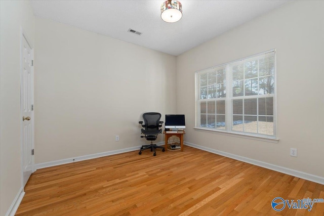 unfurnished office featuring light wood-type flooring