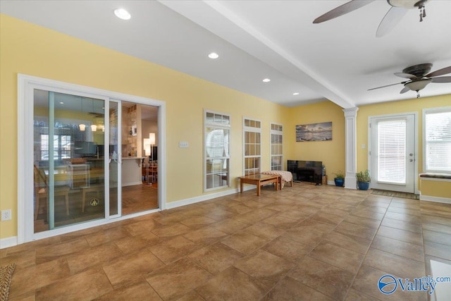 unfurnished room with ceiling fan and ornate columns