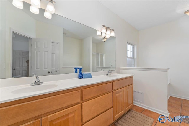 bathroom with vanity, a shower with door, and tile patterned flooring