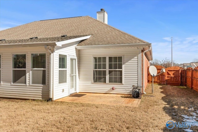 rear view of property featuring a yard and a patio