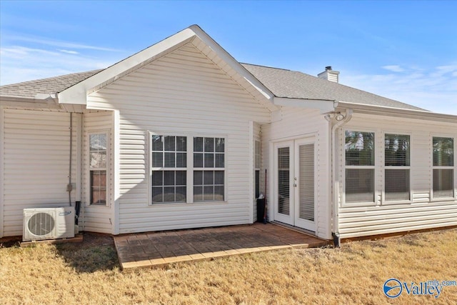 back of property with ac unit, a yard, french doors, and a patio area