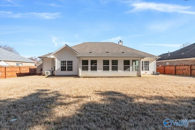 rear view of house featuring a yard