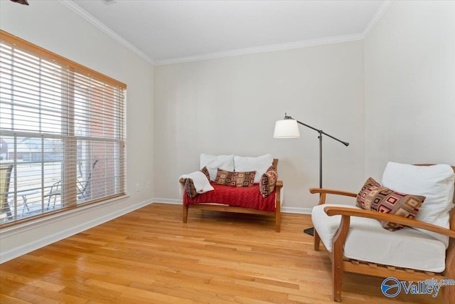 sitting room featuring hardwood / wood-style floors and crown molding