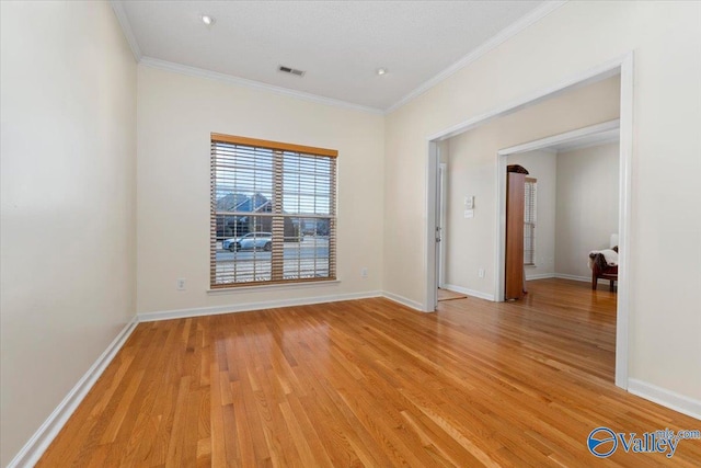 unfurnished room with light hardwood / wood-style floors and crown molding