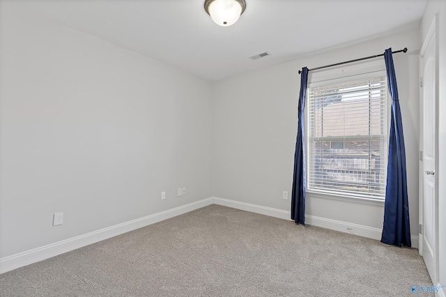 empty room featuring light carpet