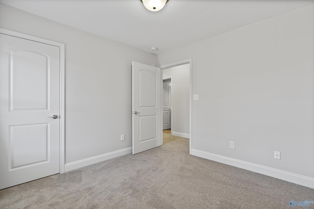 unfurnished bedroom featuring light colored carpet