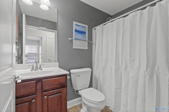 bathroom featuring toilet and vanity