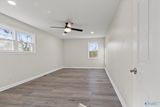 unfurnished room featuring baseboards and wood finished floors